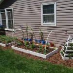 Raised beds and pyramid planter built by hand.